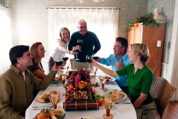 A family toasts before digging in to Thanksgiving dinner.