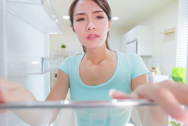 Woman looking into fridge